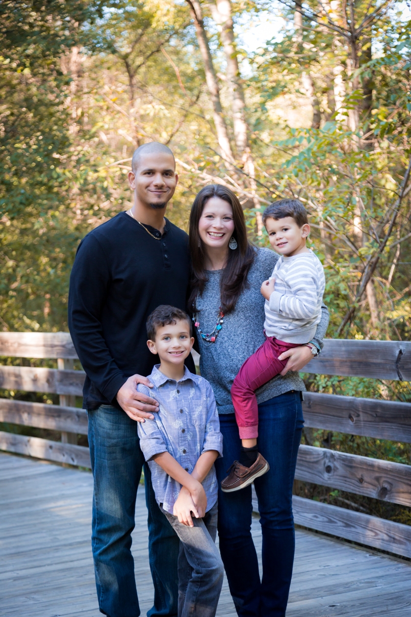 A family poses for a Christmas Card photo at White Deer Park in Garner, NC.