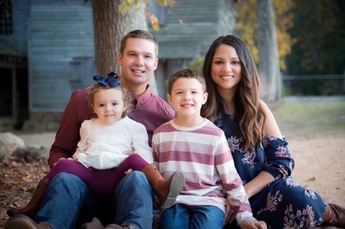 A Raleigh, NC Family site together on a blanket for their 2019 Christmas Card photo.