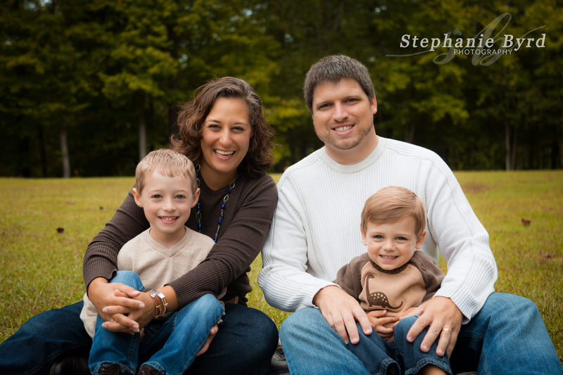 A mom laughs while posing with her husband and two sons at White Deer Park in Garner, NC