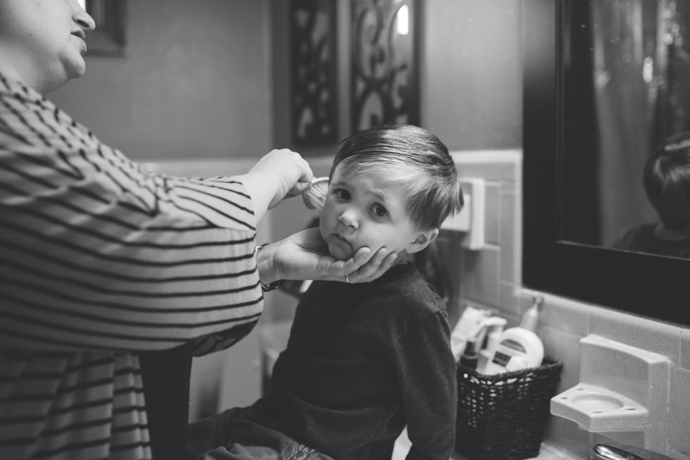 Mother brushes child's hair during a photo session in Johnston County NC