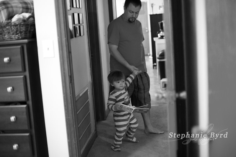 A toddler pulls Dad by the hand to go read his favorite book.